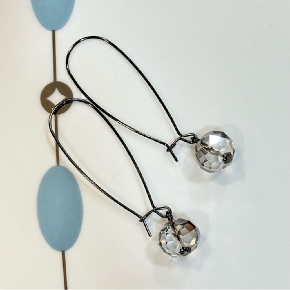 Faceted clear crystal on long wire earrings. Subtle yet eye-catching!